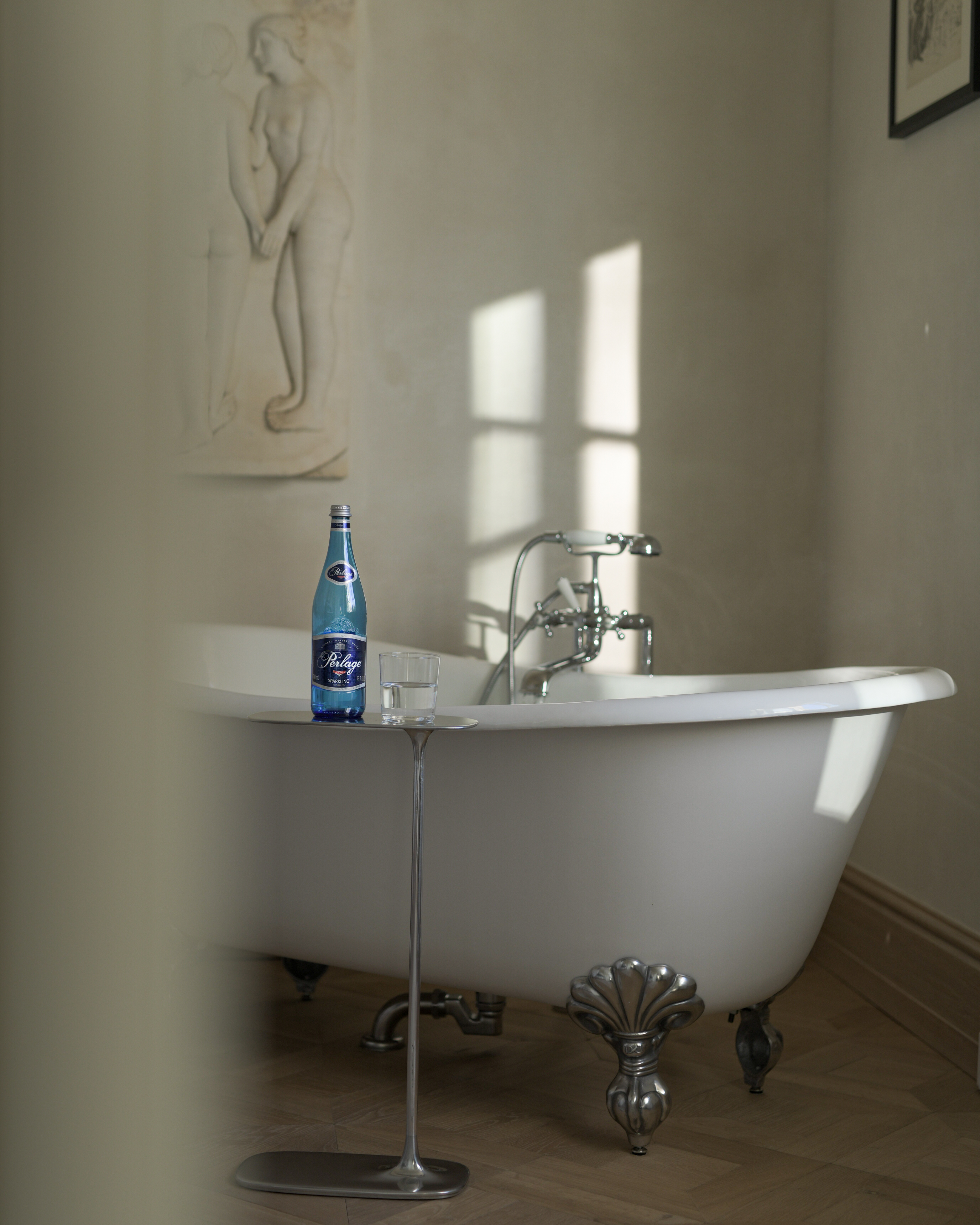 A PERLAGE bottle beside a bath