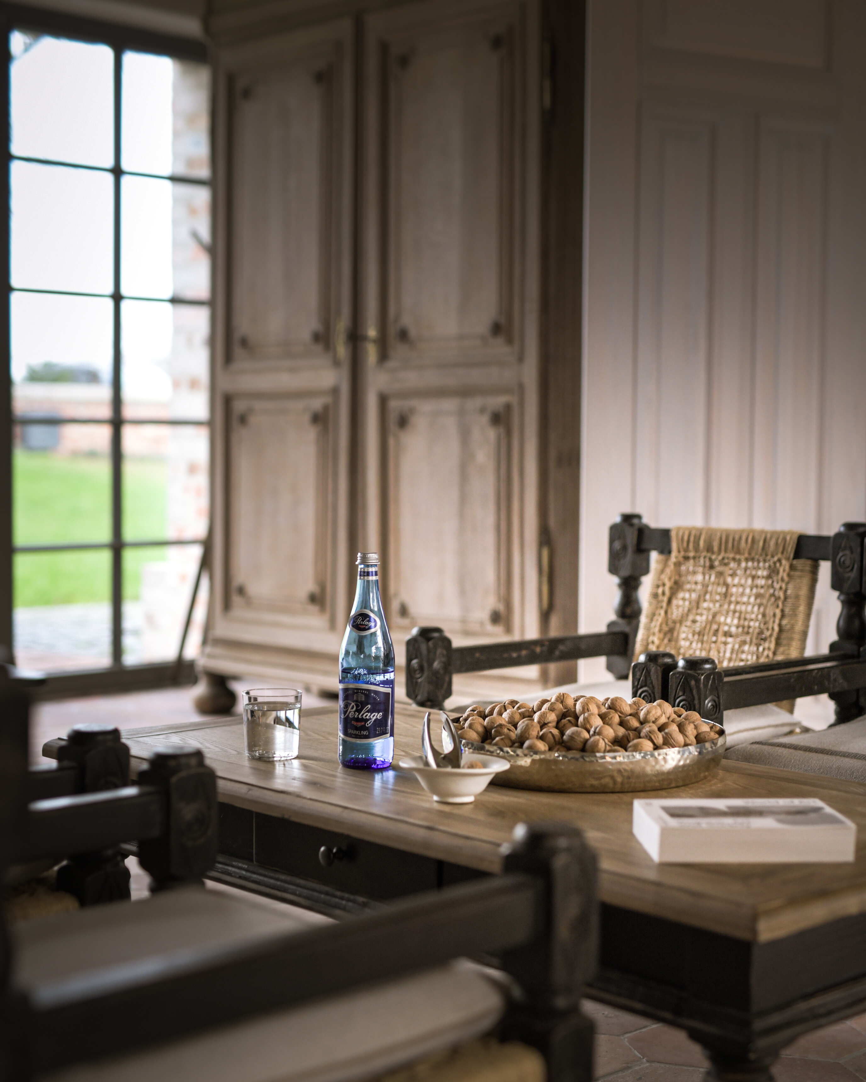 A PERLAGE bottle in an elegant dining room