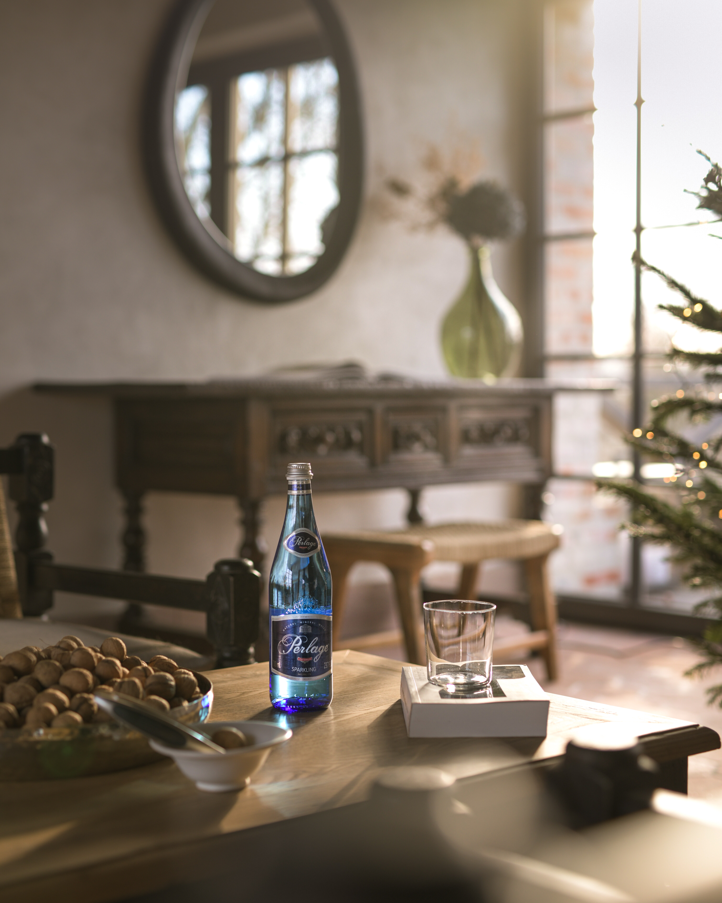 A PERLAGE bottle and glass on a table in an elegant interior